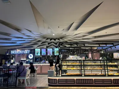 a bakery with people sitting at tables in a store at DYNAMIC SUITES by TIMES SQUARE KL in Kuala Lumpur
