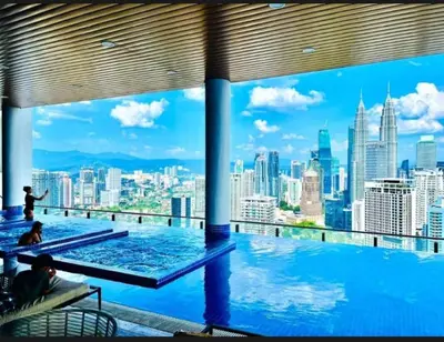 a swimming pool with a view of the city at Dreamy Destiny Suites At Infinitum KLCC Pool View in Kuala Lumpur