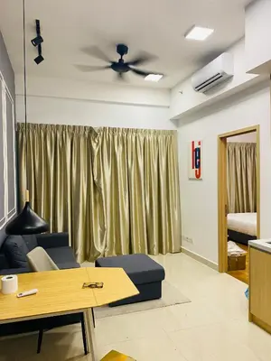 a living room with a couch and a ceiling fan at Dreamy Destiny Suites At Infinitum KLCC Pool View in Kuala Lumpur