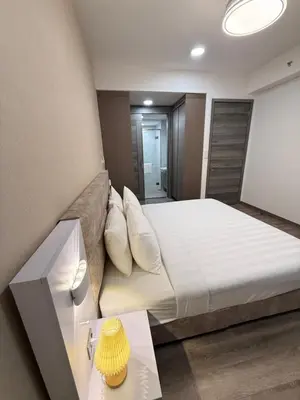a bedroom with a large bed and a mirror at Agile Delima Luxury suite Bukit Bintang in Kuala Lumpur