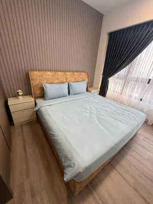 a bedroom with a large bed with blue pillows and a window at Agile Delima Luxury suite Bukit Bintang in Kuala Lumpur