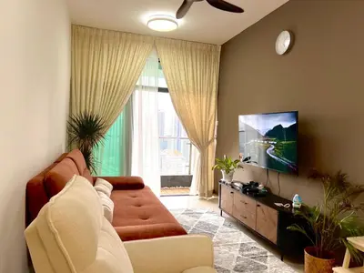 a living room with a couch and a flat screen tv at Legasi Kg Bharu with KLCC view near LRT Station in Kuala Lumpur