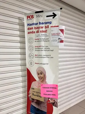 a poster of a woman with a pink sign at Legasi Kg Bharu with KLCC view near LRT Station in Kuala Lumpur