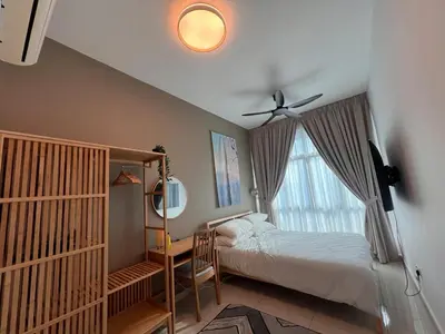 a bedroom with a bed and a window at Legasi Kg Bharu with KLCC view near LRT Station in Kuala Lumpur