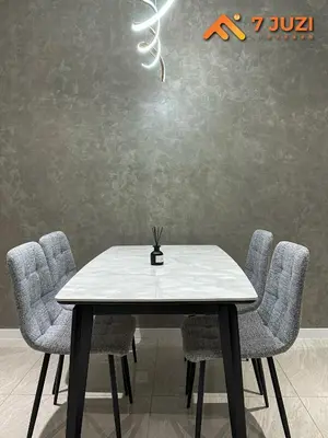 a dining room table with chairs and a light at Luxury and Cozy Suite KL and 118 TOWER View Netflix 1080HD in Kuala Lumpur