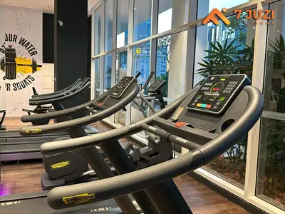 a row of treadmills in a gym at 2BED Luxury Cozy Suite 118TOWER view with NetflixHD1080 in Kuala Lumpur