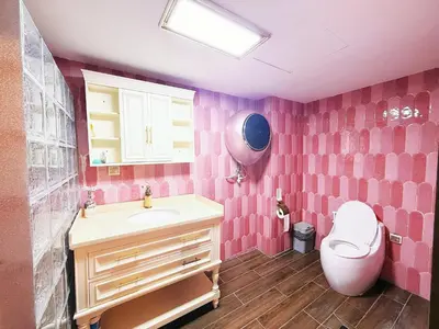 a pink bathroom with a sink and a toilet at Bintang Home in Kuala Lumpur