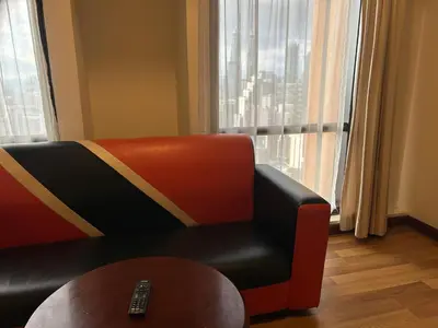 a living room with a couch and a table at TIMES SQUARE SERVICE SUITE at KUALALUMPUR in Kuala Lumpur