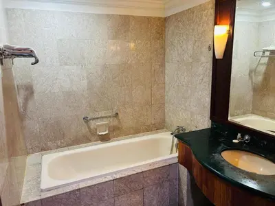 a bathroom with a bath tub and a sink at TIMES SQUARE SERVICE SUITE at KUALALUMPUR in Kuala Lumpur