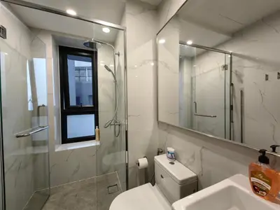 a bathroom with a toilet and a shower and a sink at TRX Agile Bukit Bintang 2 Bedroom Deluxe Suites in Kuala Lumpur