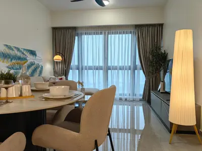 a living room with a dining room table with chairs at TRX Agile Bukit Bintang 2 Bedroom Deluxe Suites in Kuala Lumpur
