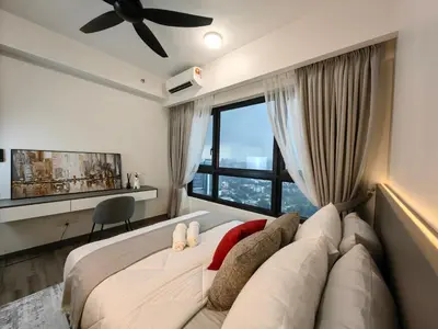 a bedroom with a large bed with a large window at TRX Agile Bukit Bintang 2 Bedroom Deluxe Suites in Kuala Lumpur