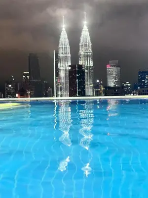 a large swimming pool with a view of the city at Dreamy Destiny Suites At KLCC Swimming Pool View in Kuala Lumpur