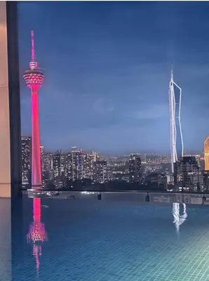a large swimming pool with a view of a city at Dreamy Destiny Suites At KLCC Swimming Pool View in Kuala Lumpur