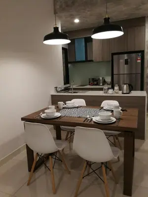a kitchen with a wooden table and white chairs at Velocity mall & Mytown ikea with Stunning KLCC view in Kuala Lumpur