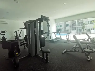 a gym with several tread machines in a building at Modern and Comforts RC Residence Fully Aircond in Kuala Lumpur