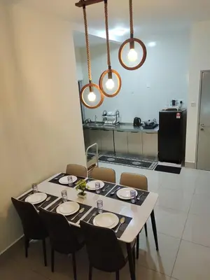 a dining room table with chairs and lights at Modern and Comforts RC Residence Fully Aircond in Kuala Lumpur