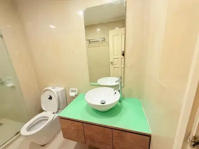 a bathroom with a sink and a toilet and a mirror at Park view Apartment near klcc in Kuala Lumpur