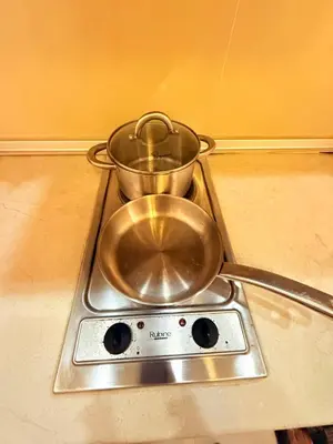 two pans sitting on top of a stove at Park view Apartment near klcc in Kuala Lumpur