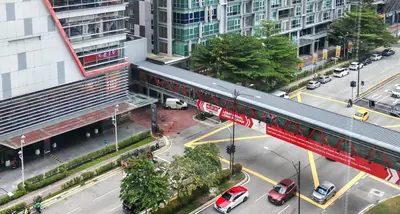 an overhead view of a busy city street with cars at Studio Sunway Velocity 2 Link Bridge to Mall in Kuala Lumpur