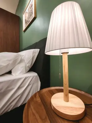 a table with a lamp on top of a bed at Studio Sunway Velocity 2 Link Bridge to Mall in Kuala Lumpur