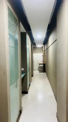 an empty hallway with doors and a tile floor at Studio apartment in Kuala Lumpur