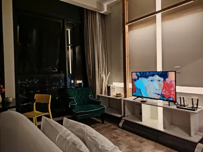 a living room with a tv and a couch at Expressionz KLCC By Laze Home in Kuala Lumpur