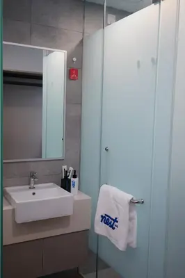 a bathroom with a sink and a mirror at Riveria City Kuala Lumpur By Nest Suites in Kuala Lumpur