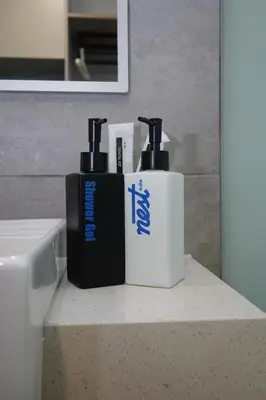 two bottles ofodorizers sitting on a counter in a bathroom at Riveria City Kuala Lumpur By Nest Suites in Kuala Lumpur