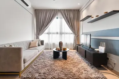 a living room with a couch and a tv at Sydney Sunset 3BR M Vertica Near MRT by RumaBnB in Kuala Lumpur