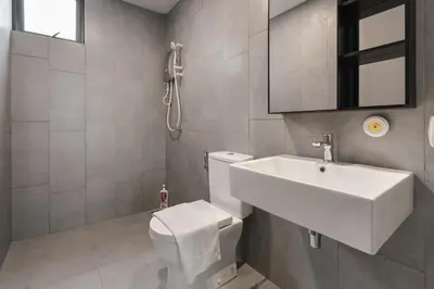 a white bathroom with a sink and a toilet at Sydney Sunset 3BR M Vertica Near MRT by RumaBnB in Kuala Lumpur
