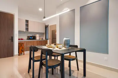 a dining room with a black table and chairs at Sydney Sunset 3BR M Vertica Near MRT by RumaBnB in Kuala Lumpur