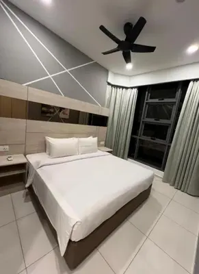 a bedroom with a bed with a ceiling fan at Parkview Family Suite klcc with views in Kuala Lumpur