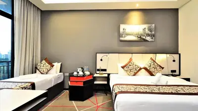 a hotel room with two beds and a window at The Oak Room At M101 in Kuala Lumpur