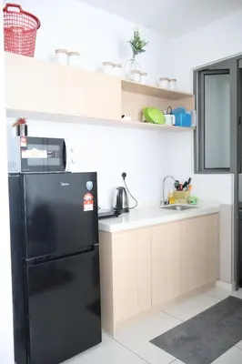 a kitchen with a black refrigerator and a sink at Cozy kenwingston platz kl 2-5pax 2BR&2BR Klcc view free paikin wifi1907 in Kuala Lumpur