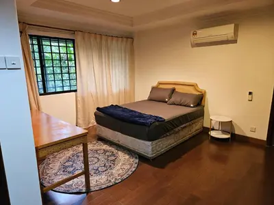 a bedroom with a bed and a table and a window at X'Apartelle near Pusat Bandar Damansara MRT in Kuala Lumpur