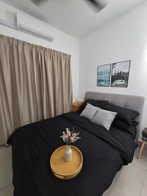 a bedroom with a black bed with a table on it at Razak Residence B2-43 RC Kuala Lumpur in Kuala Lumpur