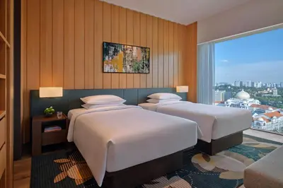 a hotel room with two beds and a window at Hyatt Regency Kuala Lumpur at KL Midtown in Kuala Lumpur