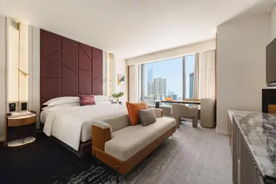 a hotel room with a bed and a couch at Kimpton Naluria Kuala Lumpur by IHG in Kuala Lumpur