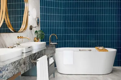a bathroom with two sinks and a bath tub at Kimpton Naluria Kuala Lumpur by IHG in Kuala Lumpur