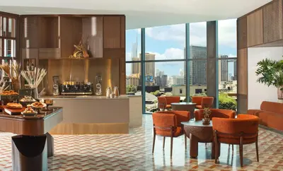 a kitchen and dining room with a view of the city at Kimpton Naluria Kuala Lumpur by IHG in Kuala Lumpur