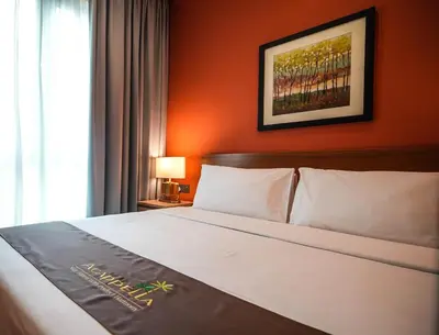 a hotel room with a bed and a window at Acappella Kuala Lumpur City Centre in Kuala Lumpur
