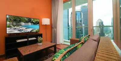 a living room with a couch and a large window at Acappella Kuala Lumpur City Centre in Kuala Lumpur