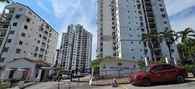 a red car parked in front of tall buildings at Pantai Hillpark phase 5 in Kuala Lumpur