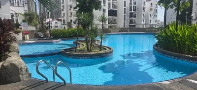 a large blue swimming pool with buildings in the background at Pantai Hillpark phase 5 in Kuala Lumpur