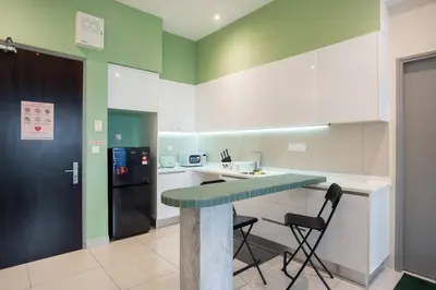 a kitchen with a counter and a refrigerator at ASTORIA Ampang Apt Designer Condo in Kuala Lumpur
