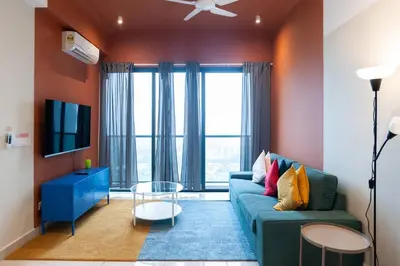 a living room with a blue couch and a tv at ASTORIA Ampang Apt Designer Condo in Kuala Lumpur