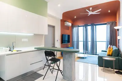 a kitchen with a table and a living room at ASTORIA Ampang Apt Designer Condo in Kuala Lumpur