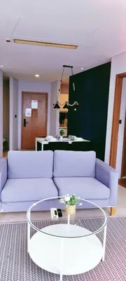 a living room with two white couches and a table at Vortex KLCC by Family Suites in Kuala Lumpur