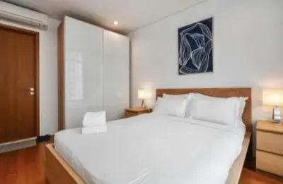 a bedroom with a large white bed in a room at Vortex KLCC by Family Suites in Kuala Lumpur